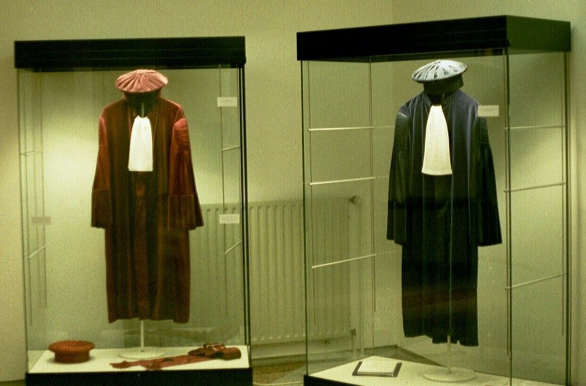 Robes of judges of the Court of Justice of the European Union, displayed in glass cases.